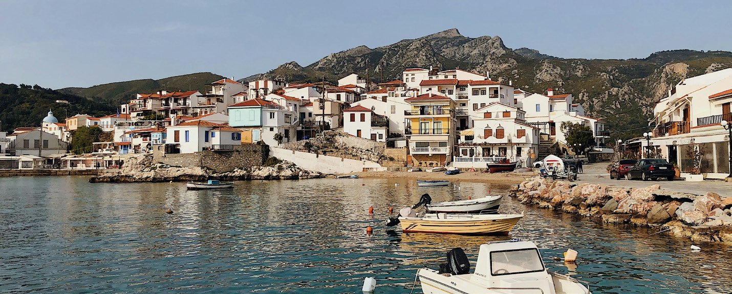 Fishing boats and waterfront houses in Kokkari, Samos